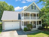 Charming two-story home with a double porch and attached garage at 1617 Heritage Garden St, Wake Forest, NC 27587