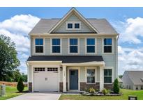 Charming two-story home featuring a well-maintained front yard and a classic architectural design at 1745 Ripley Woods St, Wake Forest, NC 27587