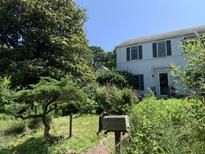 Charming two-story home with a mailbox and lush, mature landscaping at 1800 Avondale Dr, Durham, NC 27701