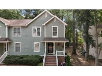 Charming two-story home featuring a covered front porch and tidy landscaping at 1815 Crystal Downs Lane, Raleigh, NC 27604