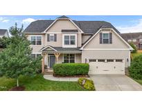 Traditional two-story home with neutral siding, gray shutters, and an attached two-car garage at 184 Elgin Ct, Burlington, NC 27215