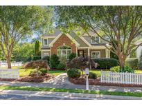 Charming two-story home with a brick accent, mature trees, and a well-manicured lawn at 20002 Fountain, Chapel Hill, NC 27517