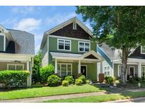 Charming two-story home with a inviting front porch and beautifully landscaped front yard at 2112 Dunn Rd, Raleigh, NC 27614