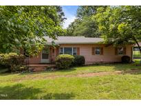 Charming single-story home with a well-maintained front yard and mature landscaping at 416 Forrest St, Hillsborough, NC 27278