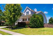 Charming two-story home with a well-manicured front yard and welcoming porch at 42 Juneberry Dr, Chapel Hill, NC 27516