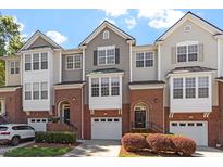 Charming townhome with brick accents, attached garage, and inviting curb appeal at 4533 Pale Moss Dr, Raleigh, NC 27606