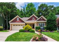 Charming home featuring well-manicured lawn and meticulously landscaped front yard at 553 Lake Gaston Dr, Fuquay Varina, NC 27526