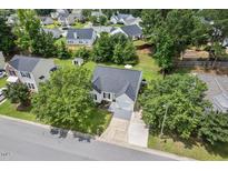 Inviting single-story home with a well-manicured lawn and mature trees in a peaceful neighborhood at 611 Quartz Dr, Durham, NC 27703