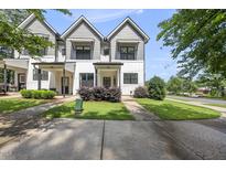 Charming two-story townhouse with gray and white exterior and well-manicured landscaping at 6300 Pleasant Pines Dr # 101, Raleigh, NC 27613