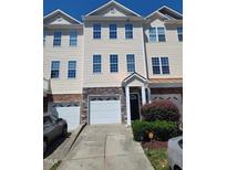 Charming townhome with stone accents, three stories and attached garages at 650 Ganyard Farm Way # 32, Durham, NC 27703