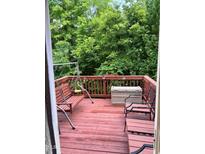 View of the deck with a swing and seating, overlooking lush greenery at 651 Berry Chase Way, Cary, NC 27519