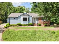 Charming home with a well-manicured front yard and a mix of brick and siding exterior at 716 Sandra St, Garner, NC 27529