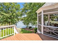Inviting screened porch offers serene lake views and access to an outdoor deck at 81002 Alexander, Chapel Hill, NC 27517