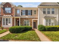 Charming townhome with stone accents, a well-manicured lawn, and a welcoming front entryway at 8422 Central Dr, Raleigh, NC 27613