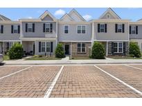 Charming townhome with gray siding, black shutters, and neat landscaping at 8885 Commons Townes Dr, Raleigh, NC 27616