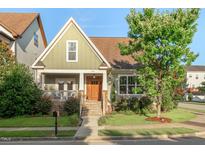 Inviting craftsman-style home with a well-manicured lawn and charming front porch at 997 Windy Rd, Apex, NC 27502