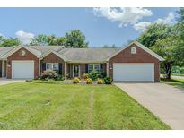 Charming brick and siding home with a well-maintained lawn and attached one car garage at 101 Kingston Ln, Graham, NC 27253