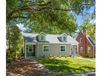 Charming grey home featuring a well-manicured lawn and dormer windows at 1022 Carolina Ave, Durham, NC 27705