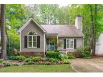 Charming home featuring a landscaped front yard, a welcoming blue door and a cozy, quaint curb appeal at 112 Barcelona Ct, Cary, NC 27513