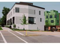 Modern, three-story building with white brick and black-trimmed windows on a sunny day at 1311 Chamblee Hill Ct, Raleigh, NC 27608
