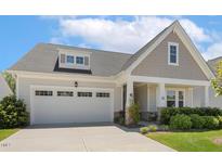 Charming home featuring a two-car garage, covered porch, and well-maintained landscaping at 149 Ivory Ln, Raleigh, NC 27610