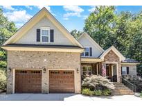 Charming two-story home with a two-car garage, beautiful brick facade and manicured landscaping at 150 Luxorwind Dr, Garner, NC 27529