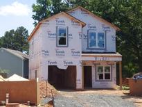 New construction with Tyvek wrap and architectural details, awaiting finishing touches for its future residents at 1804 Falls Landing Dr, Raleigh, NC 27614
