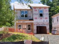 New home construction featuring protective wrap and visible framing at 1808 Falls Landing Dr, Raleigh, NC 27614
