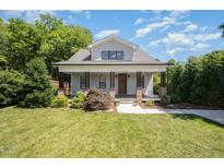 Charming two-story home with a welcoming front porch and beautiful landscaping at 200 W Corbin St, Hillsborough, NC 27278