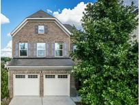 Charming two-story brick home features a two-car garage and manicured landscaping at 2007 October Dr, Durham, NC 27703