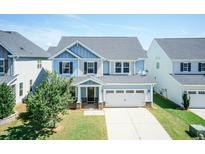Charming two-story home featuring a manicured lawn and a two-car garage on a sunny day at 2008 Campana Dr, Raleigh, NC 27603