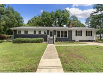 Charming single-story home with manicured lawn, newly painted exterior and inviting entryway at 202 Purvis St, Garner, NC 27529