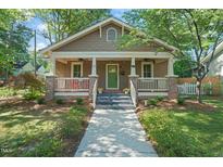 Charming craftsman home with covered front porch, landscaped yard, and inviting curb appeal at 211 W Trinity Ave, Durham, NC 27701