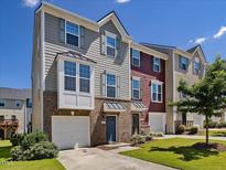 Charming townhome with well-maintained lawn, attached garage, and brick accents at 215 Brier Summit Pl, Durham, NC 27703