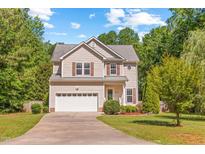 Charming two-story home featuring a well-maintained lawn and an attached two-car garage at 2555 Winding Creek Ln, Franklinton, NC 27525