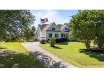 Charming home featuring a well-manicured lawn, driveway, and an American flag proudly displayed at 2813 Greenridge View Ln, Zebulon, NC 27597