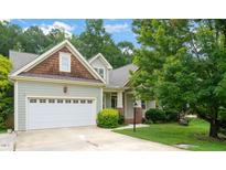 Charming craftsman-style home featuring a two-car garage and well-maintained landscaping at 322 Bellemont Rd, Pittsboro, NC 27312