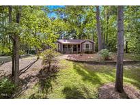 Charming home nestled among mature trees with a well-maintained lawn at 4816 Marlborough Way, Durham, NC 27713