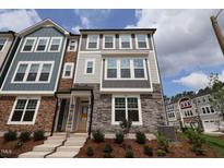 Charming townhome exterior featuring a combination of stone and siding, with a welcoming front entrance at 5031 Se Jowetts Walk Dr # 28, Cary, NC 27519