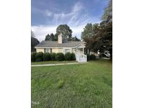 Charming single-story home with a well-manicured lawn and inviting front porch at 5809 Iris Lake Ct, Raleigh, NC 27604