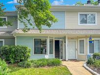 Charming townhome exterior featuring well-manicured landscaping and a welcoming entryway at 5810 Shady Grove Cir, Raleigh, NC 27609