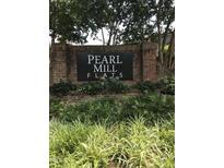 Pearl Mill Flats brick sign with lush landscaping offers a welcoming entrance to the community at 807 W Trinity Ave # 209, Durham, NC 27701