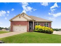 Lovely one-story red brick house with a manicured lawn and a two-car garage at 88 Longo Ln, Benson, NC 27504