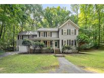 Charming two-story home with a cozy front porch and well-maintained landscaping at 10836 Wilmore Dr, Raleigh, NC 27614