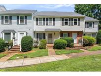 Charming townhouse with neat landscaping, sidewalk and traditional architectural details at 14 Quintin Pl, Durham, NC 27705