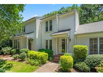 Charming two-story home with manicured landscaping, brick walkway and covered front porch at 144 Greenmont Ln, Cary, NC 27511