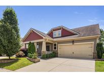 Charming home with a well-manicured lawn, two-car garage, and inviting front porch at 1523 Anthology Dr, Durham, NC 27703