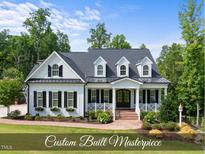 Stunning two-story home with a well-manicured lawn and beautiful landscaping at 175 Stonecrest Way, Pittsboro, NC 27312