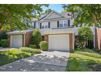 Charming townhouse with attached garage, neutral siding, black shutters, and well maintained landscaping at 2069 White Pond Ct, Apex, NC 27523