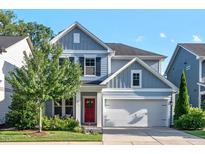 Charming two-story home with a well-manicured lawn, two car garage and a striking red front door at 217 Macy Grove Dr, Chapel Hill, NC 27517
